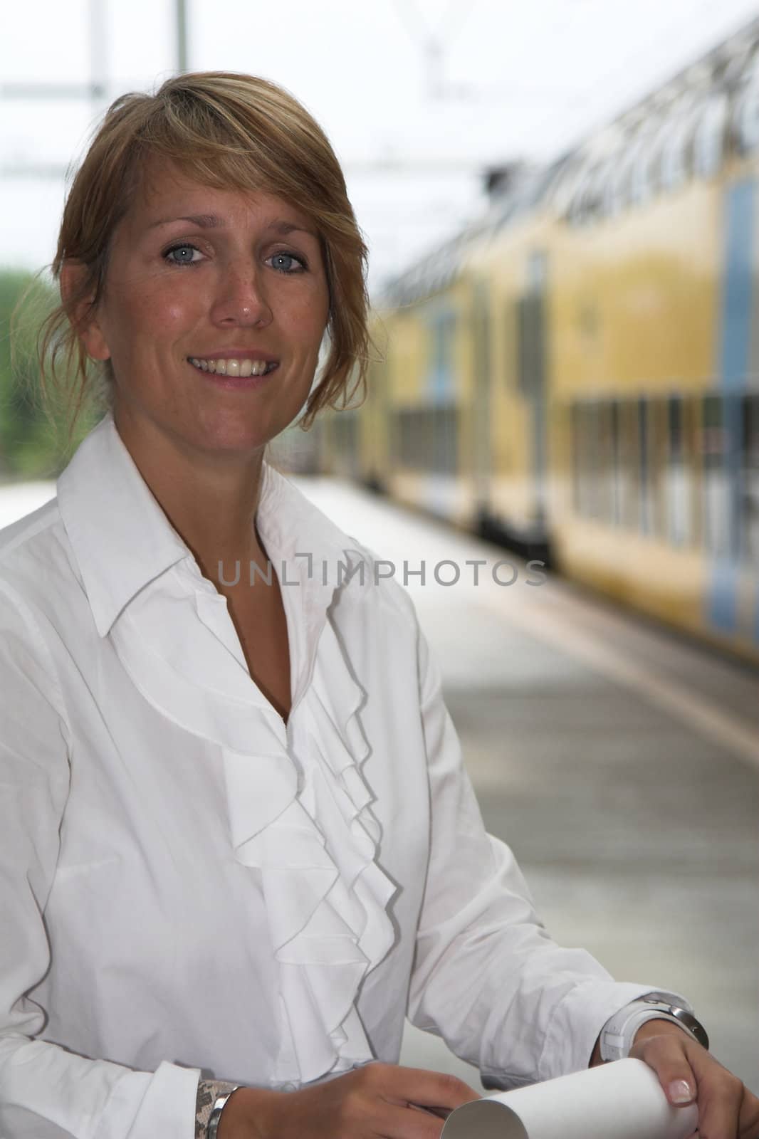 Pretty businesswoman waiting for the train to arrive