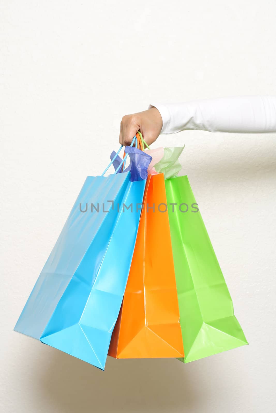 A hand carrying shopping bags