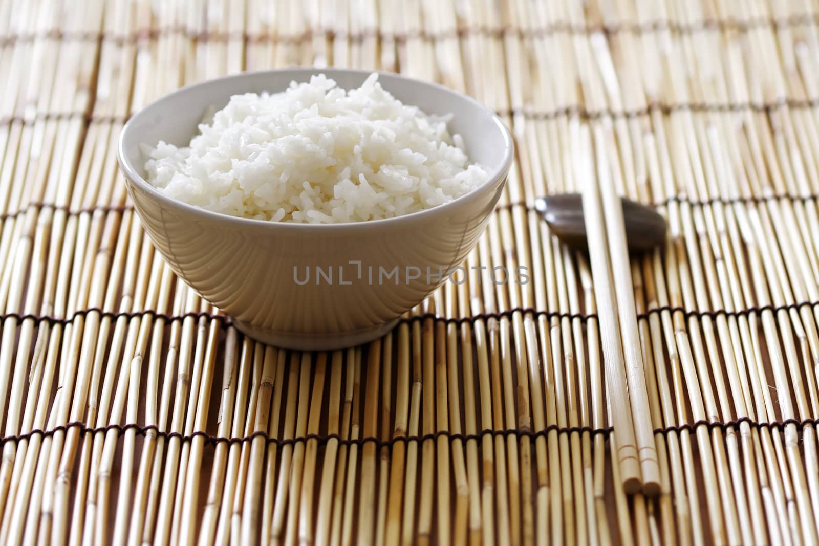 A bowl of rice and chopsticks