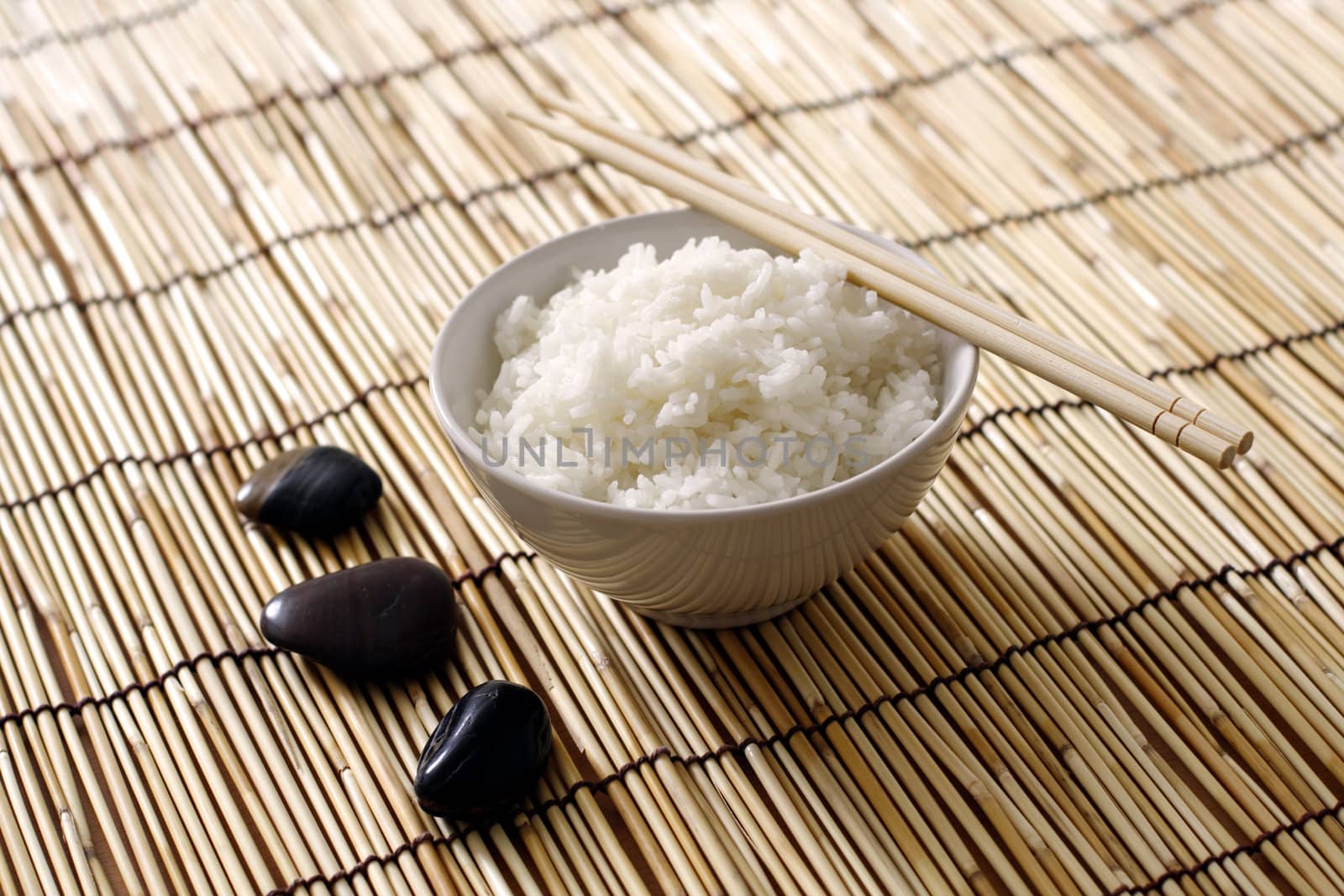 A bowl of rice and stones in zen environment