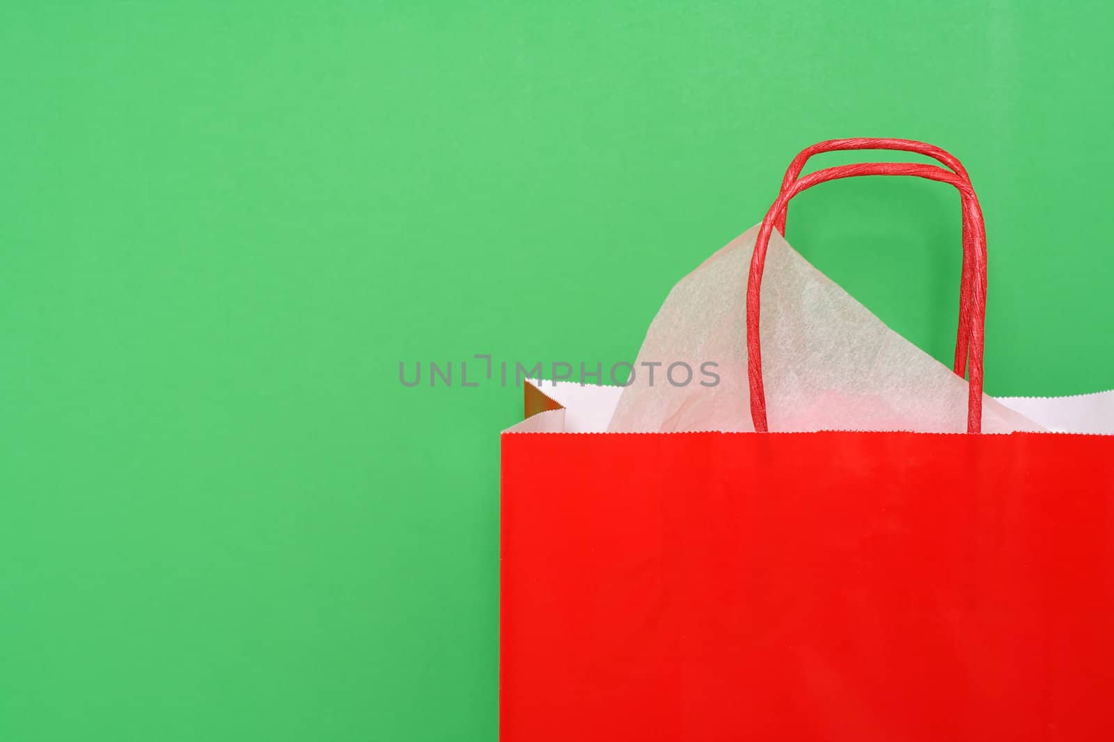 Red shopping bag on green background