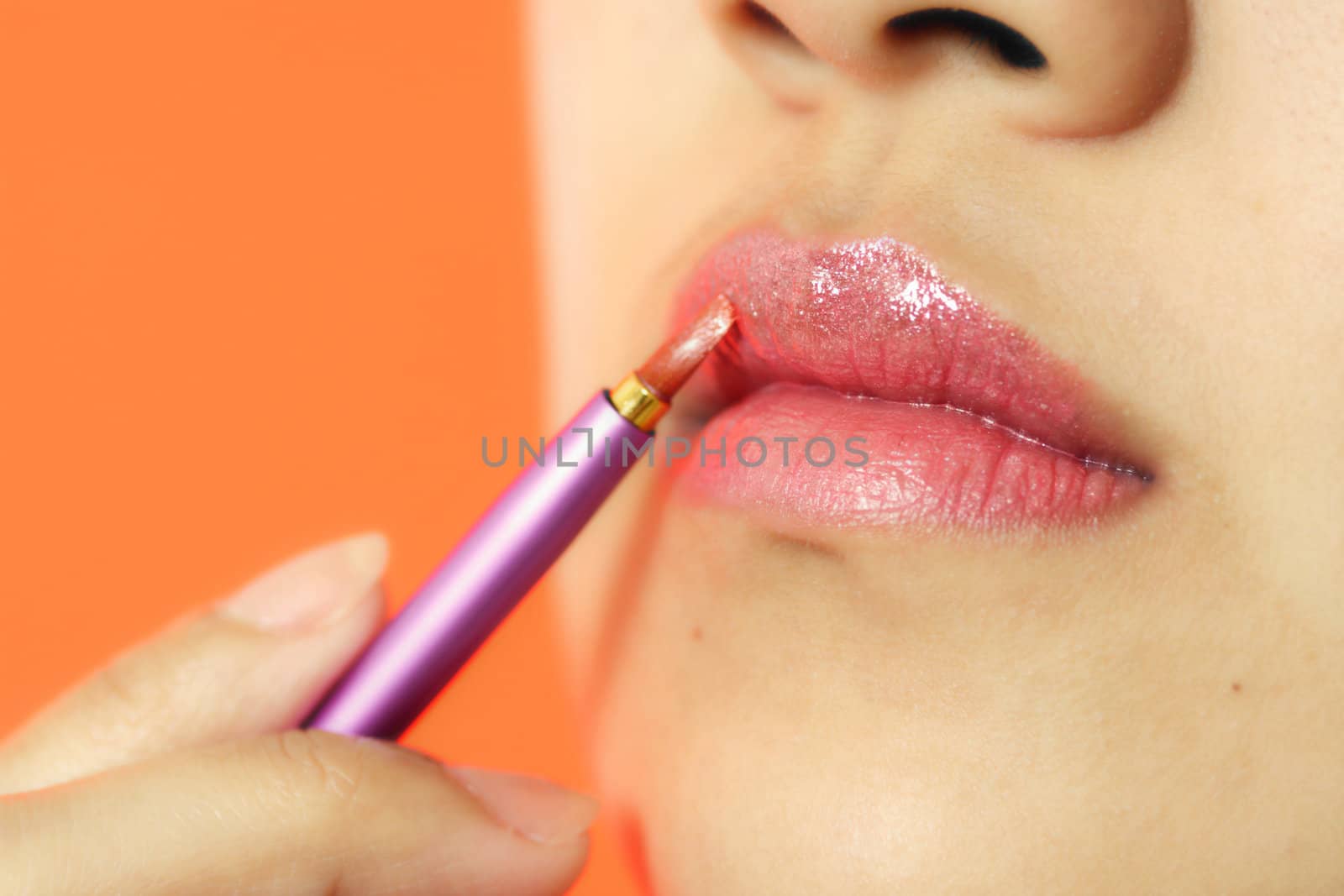 A woman applying make-up/cosmetics