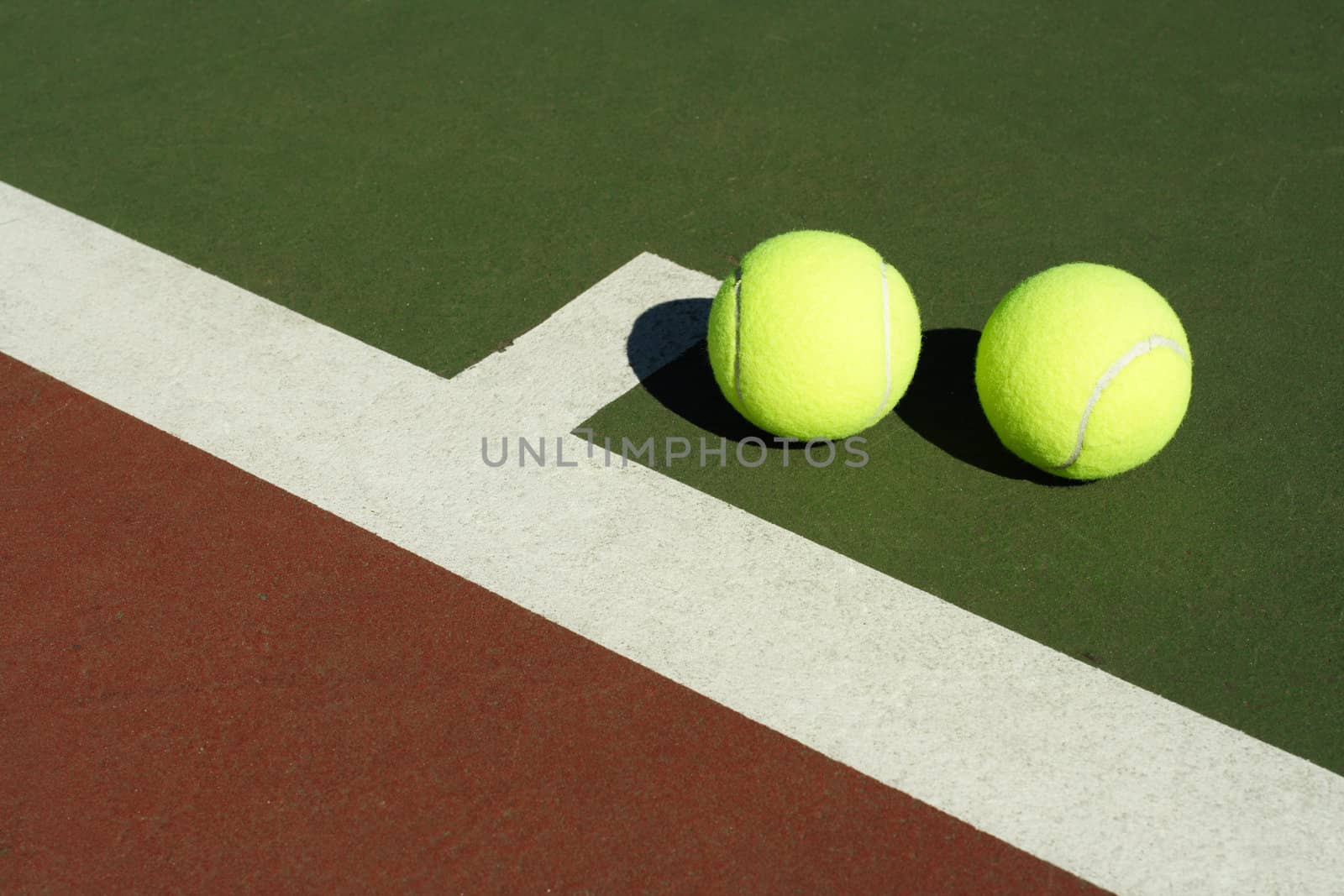 Two tennis balls in a tennis court