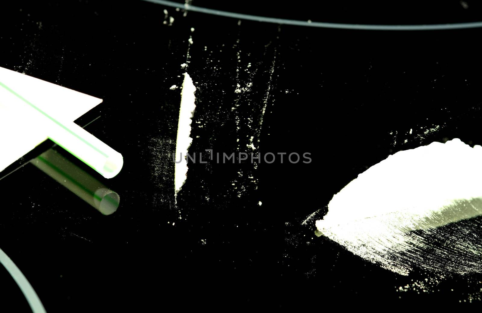 Cocaine and lines (flour) on a black reflective surface