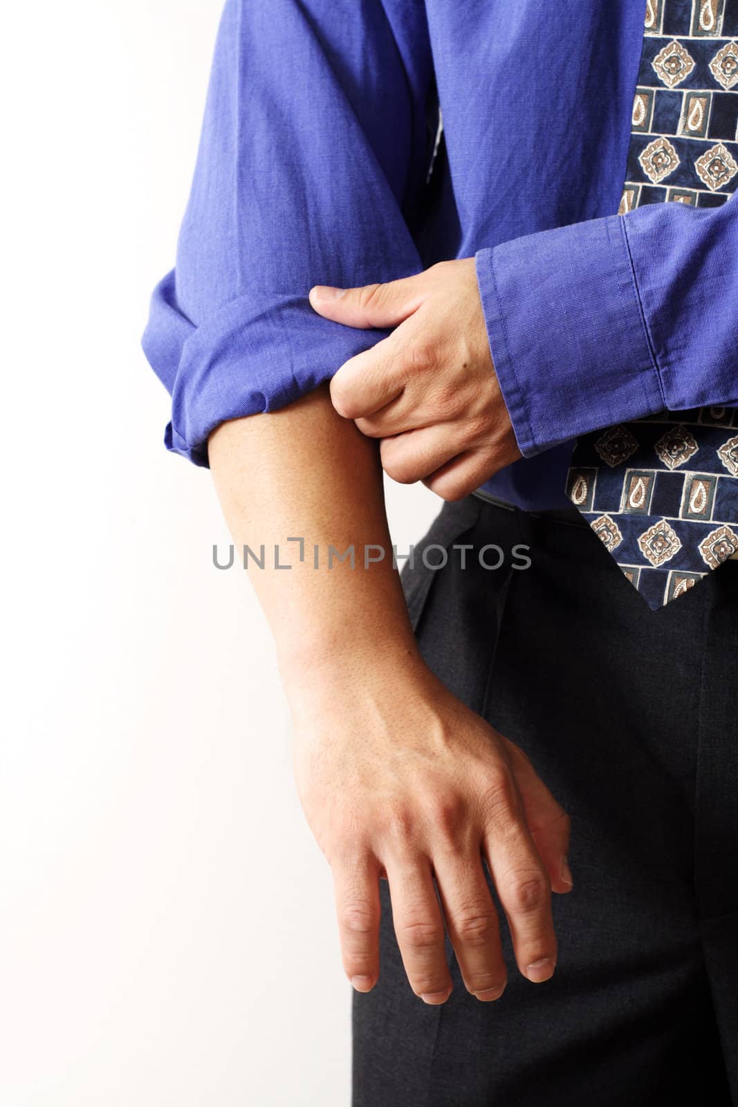 A businessman rolling up his sleeves