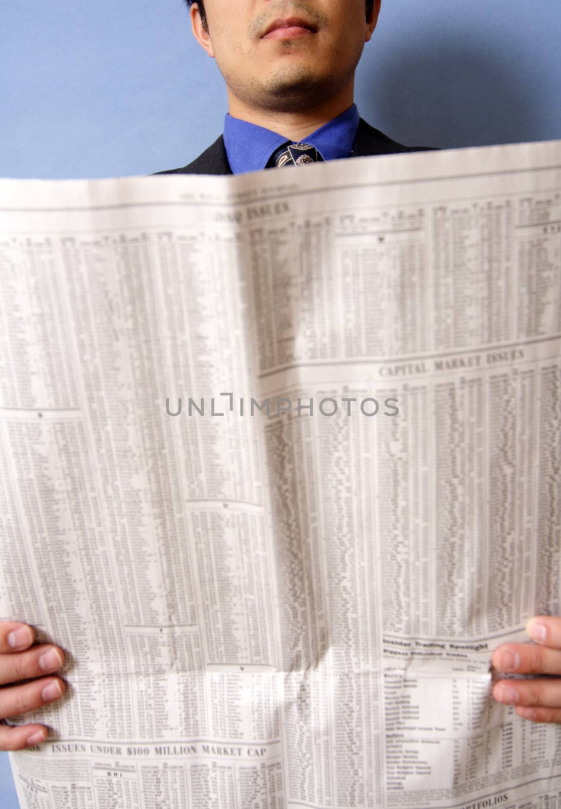 A businessman reading a financial newspaper