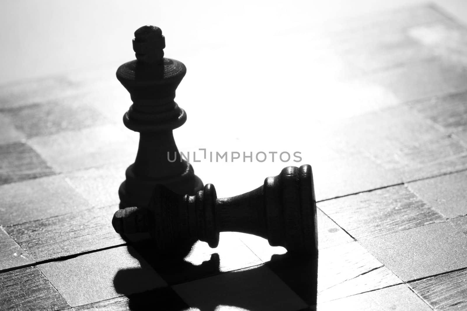 Two pieces of chess, one has won against the other