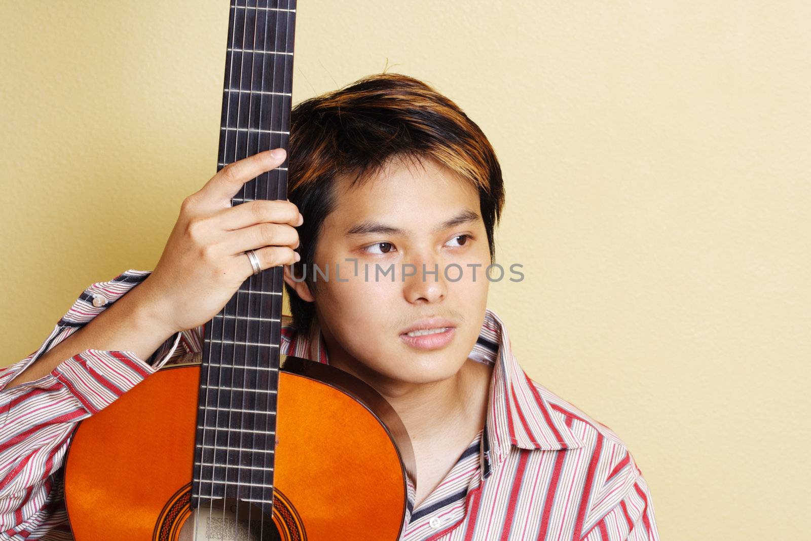 A young man with a guitar