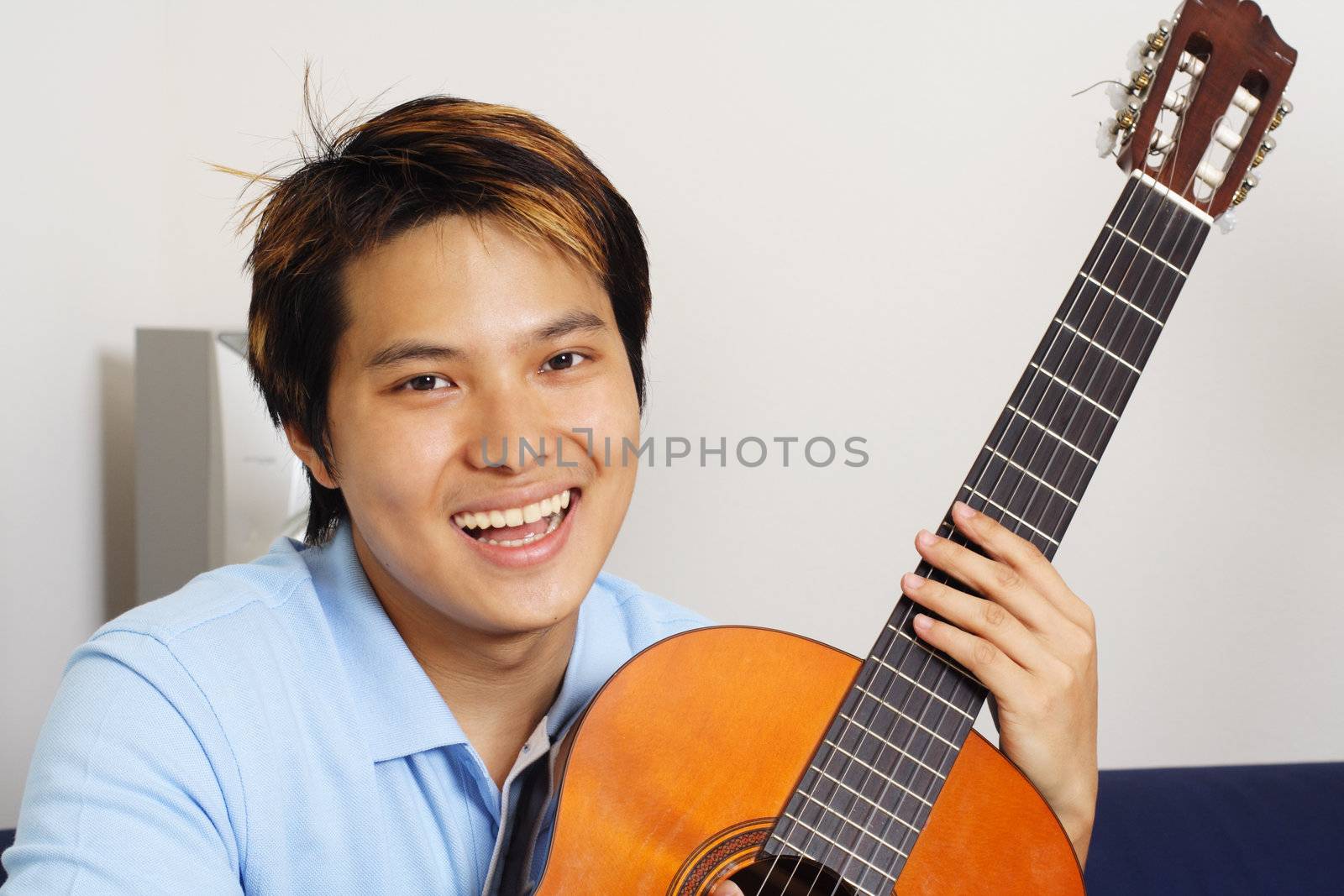 A young man playing guitar