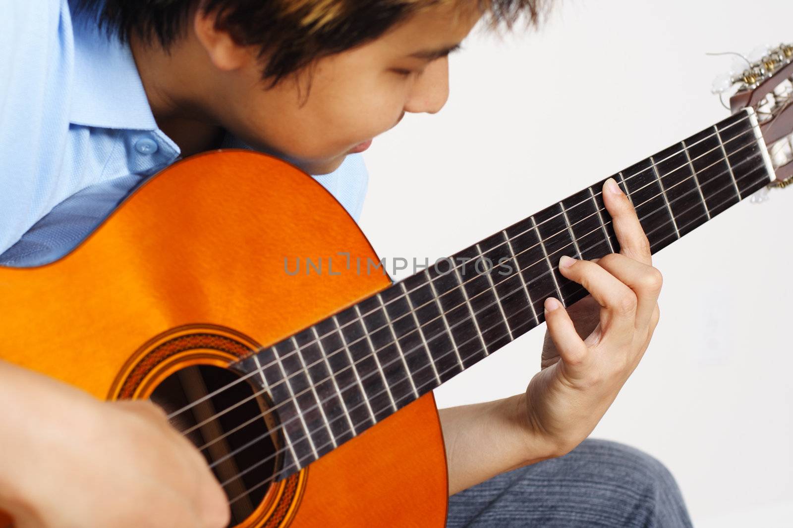 A young man playing guitar