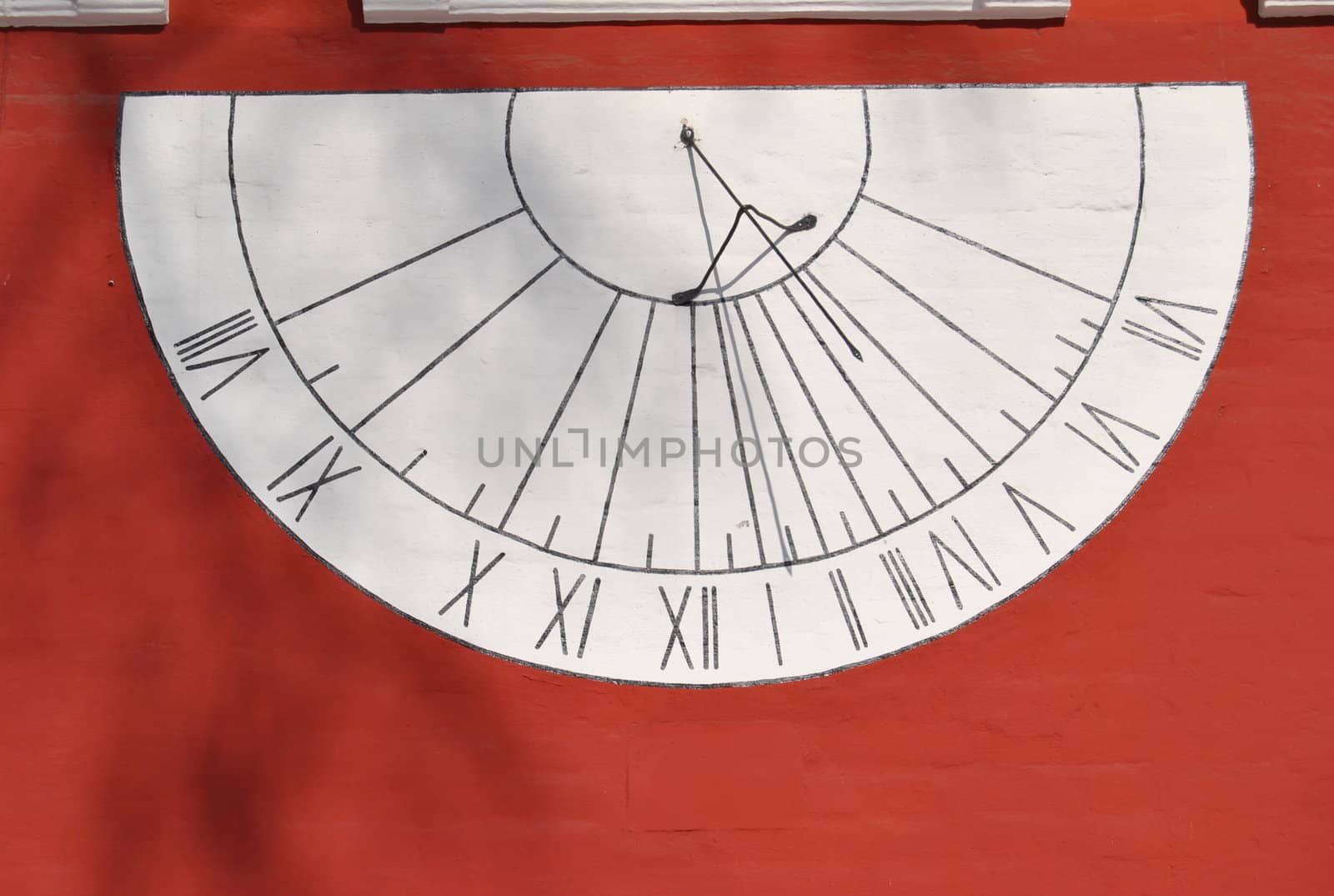 Antique sundial on the red walls of the Novodevichy Orthodox nunnery in Moscow