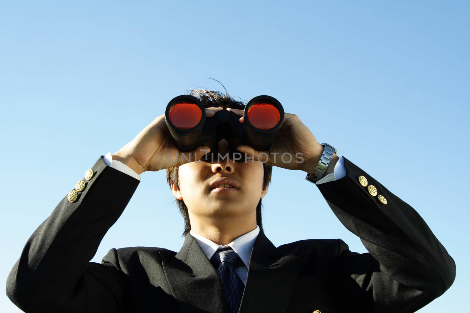 Businessman looking through binoculars, can be used for vision/prospects metaphor