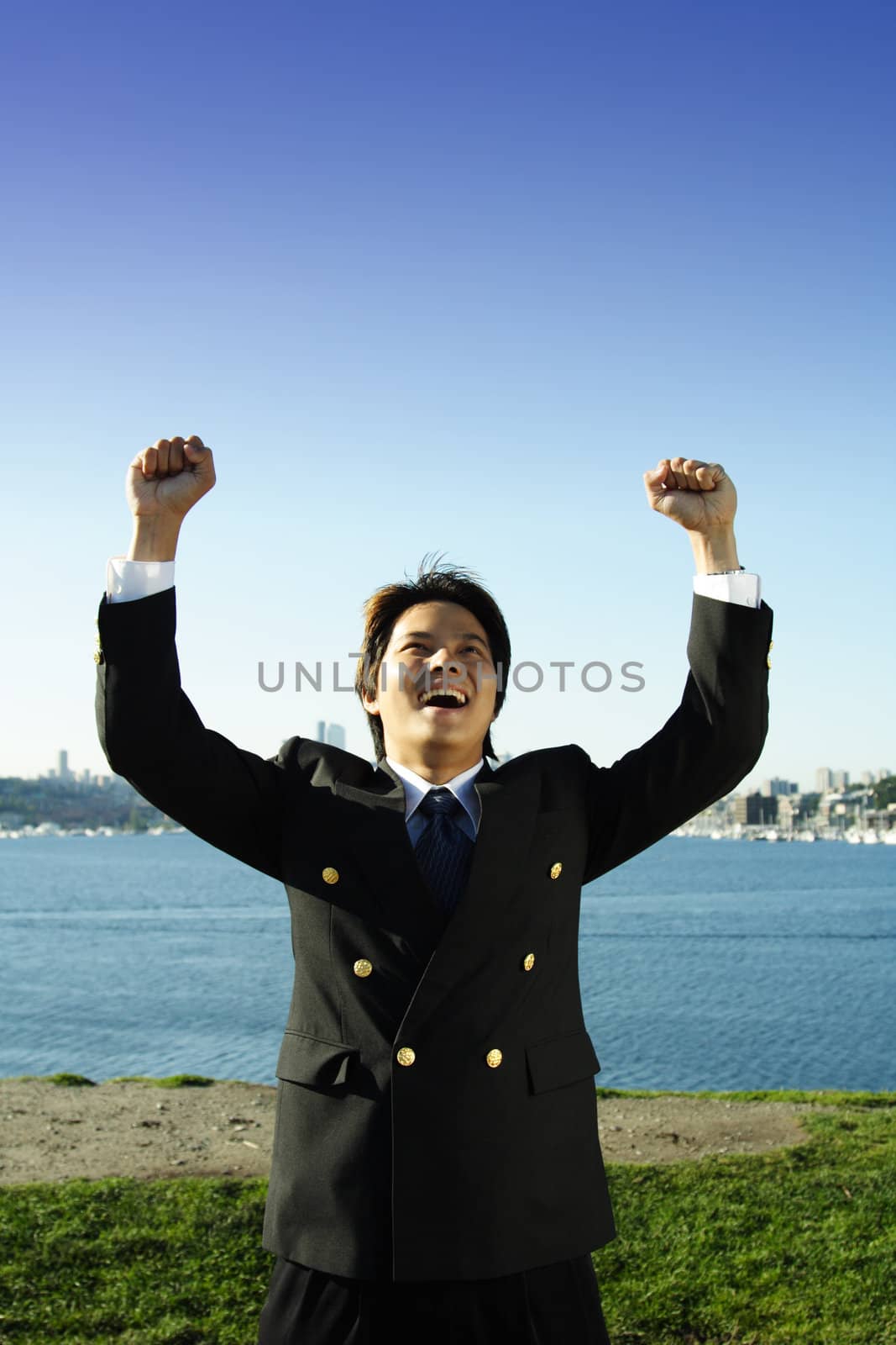 Happy businessman with two arms up in the air