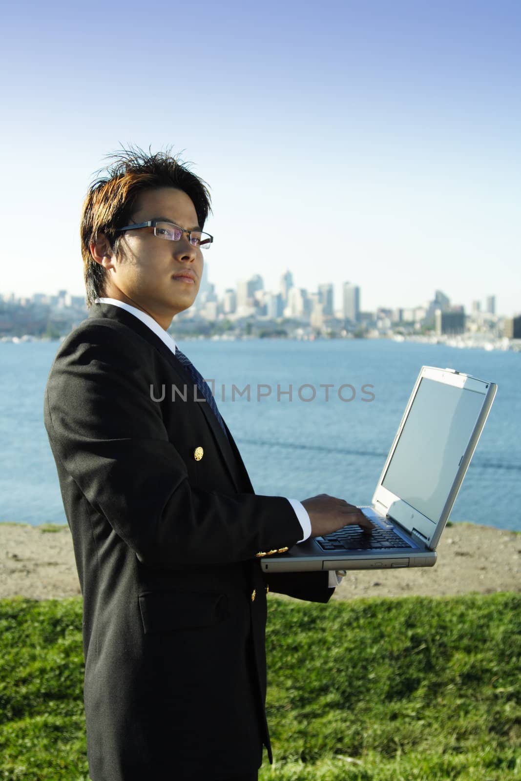 Businessman working on his laptop at a park