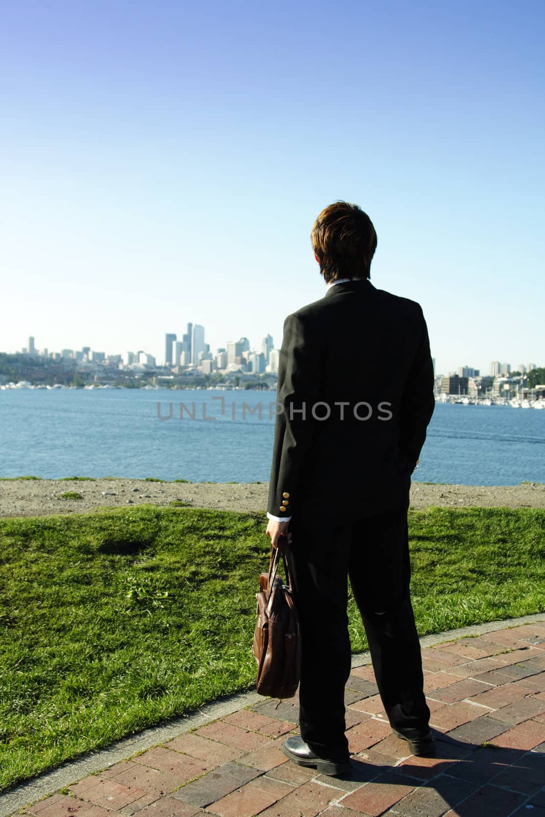 Businessman looking towards downtown buildings