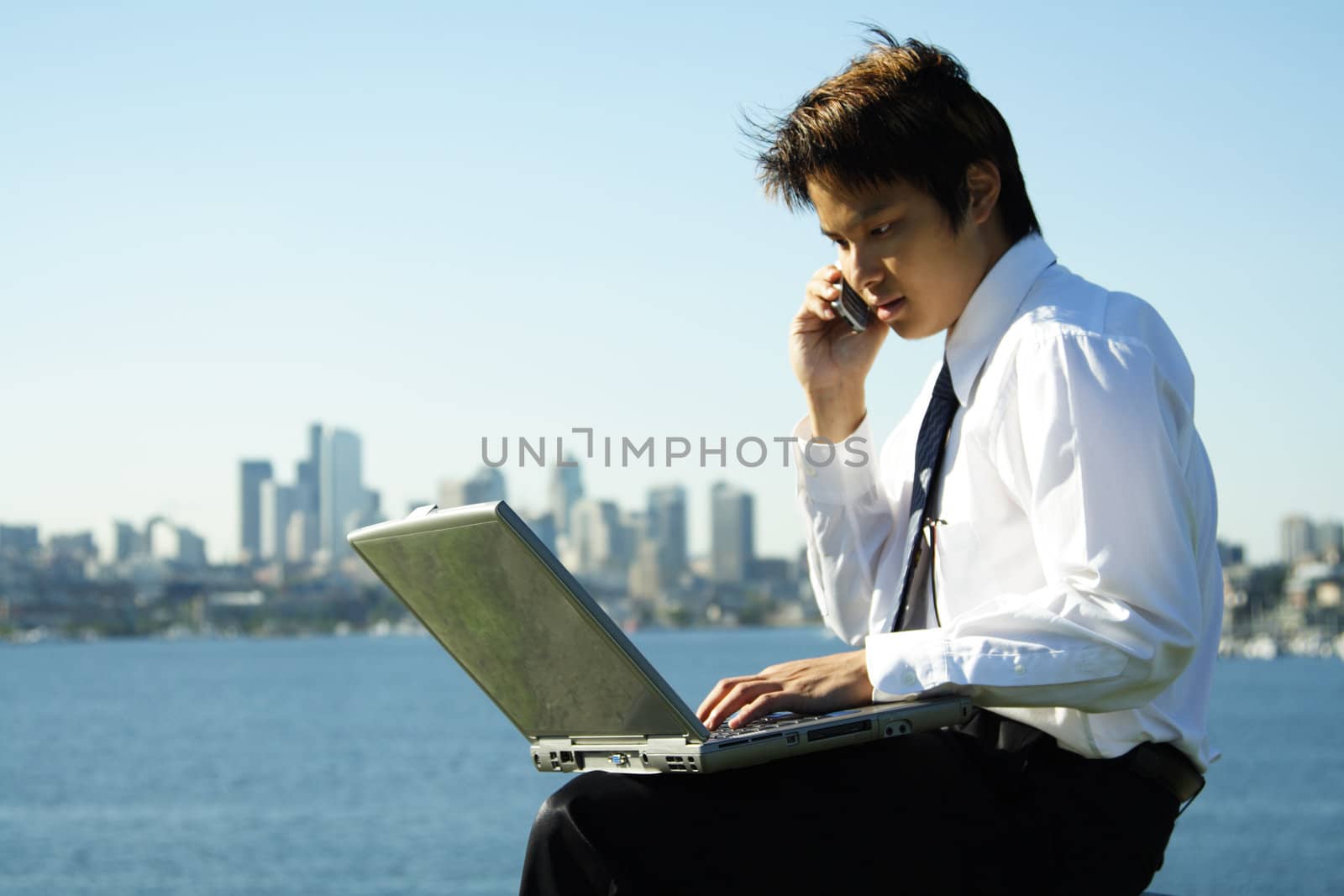 A businessman working outdoor at a park