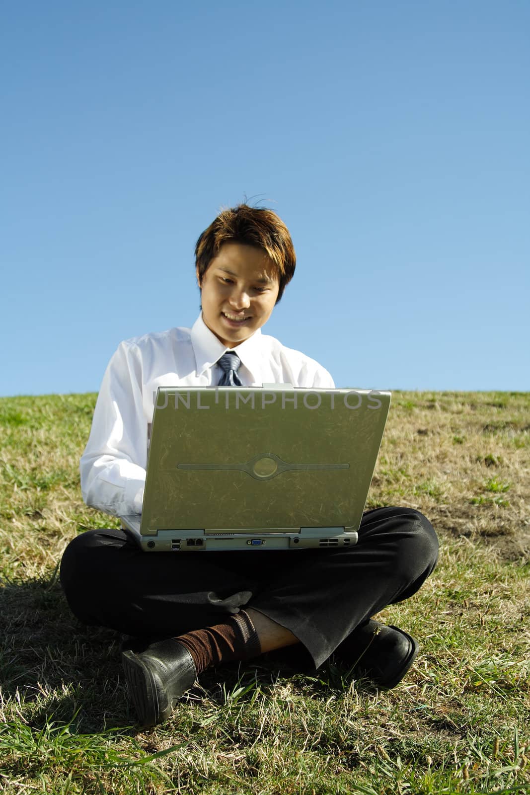 A businessman working on his laptop outdoor