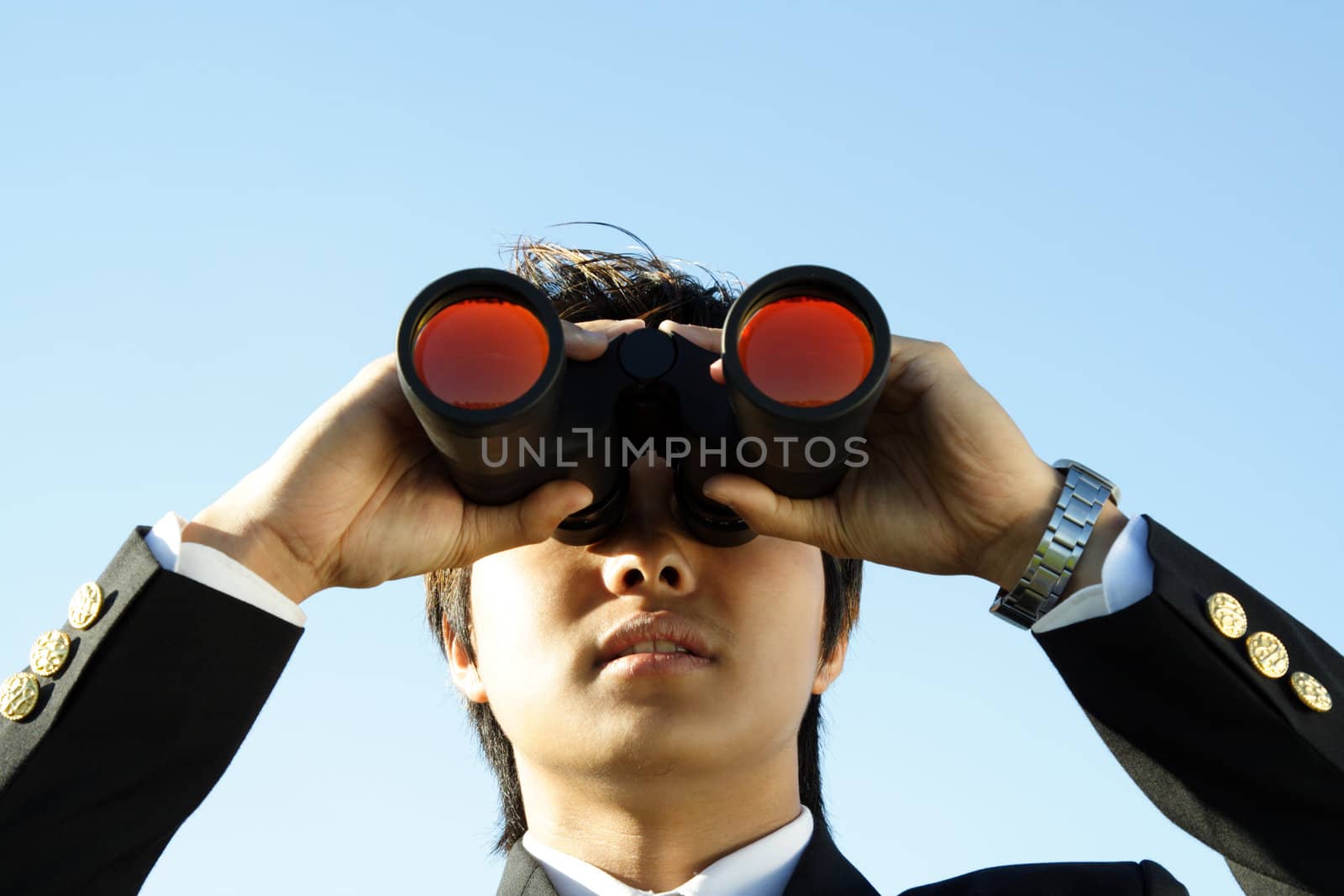 Businessman looking through binoculars, can be used for vision/prospects metaphor