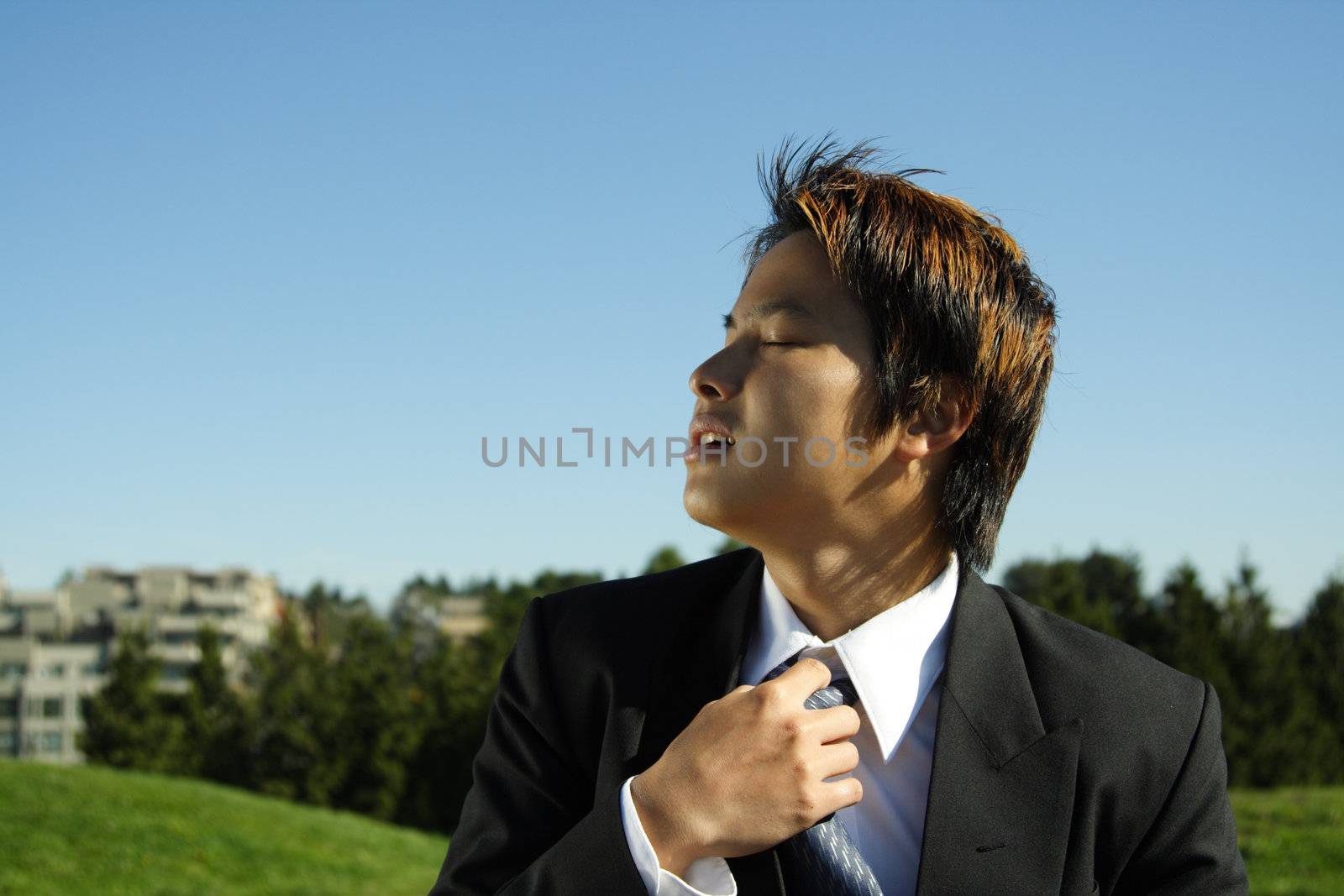 A businessman at an outdoor park