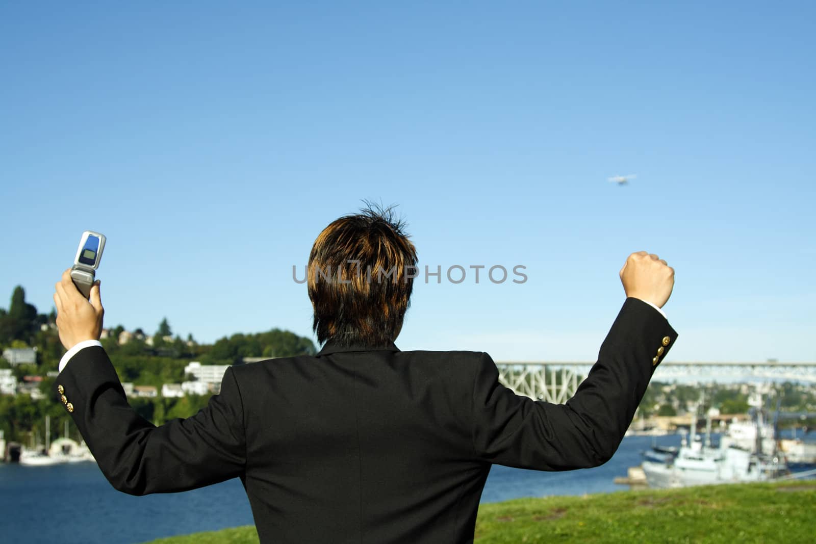 Happy businessman with arms up in the air