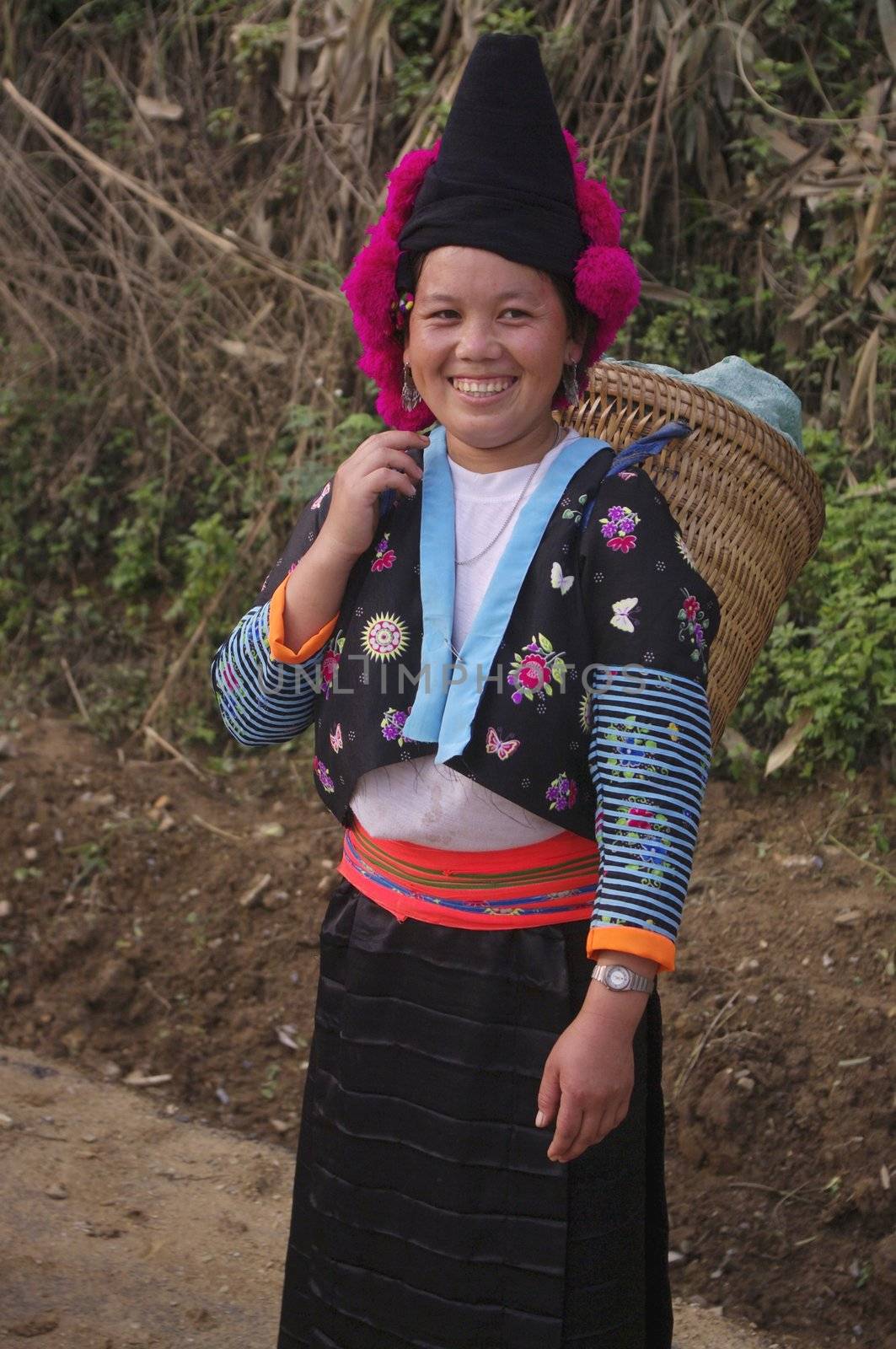 Headdress typical of young Hmong girls red pompoms unmarried. Woman Pha Din Pass