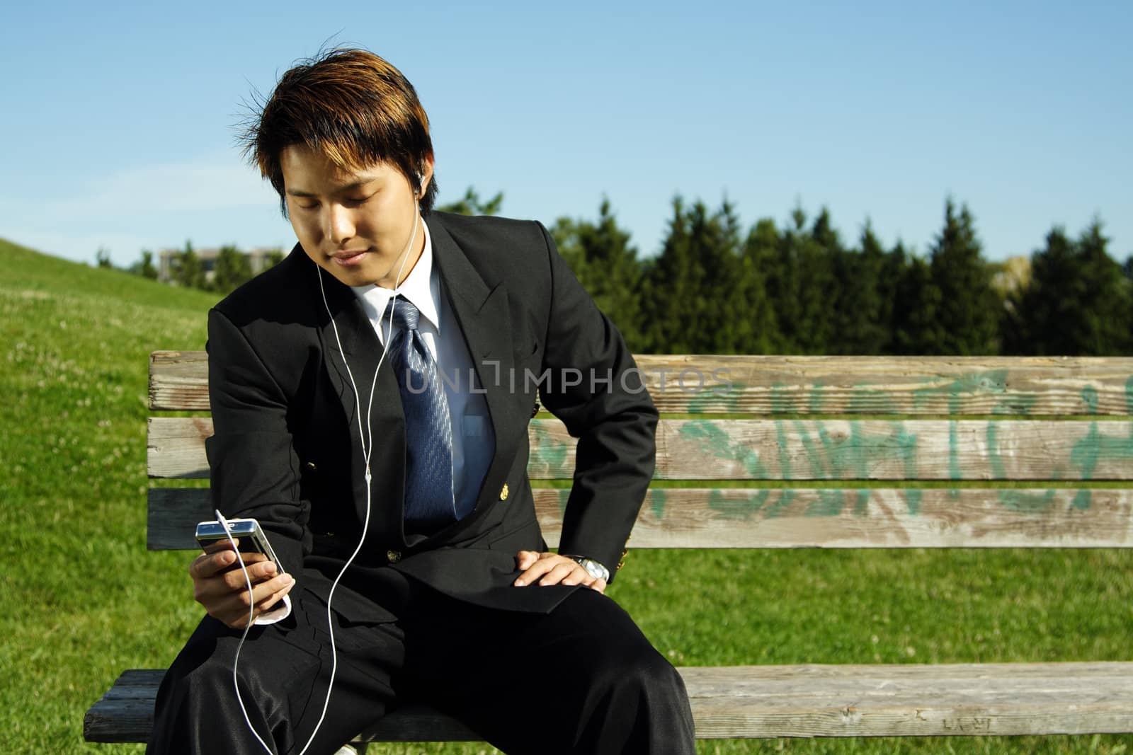 A businessman listening to music