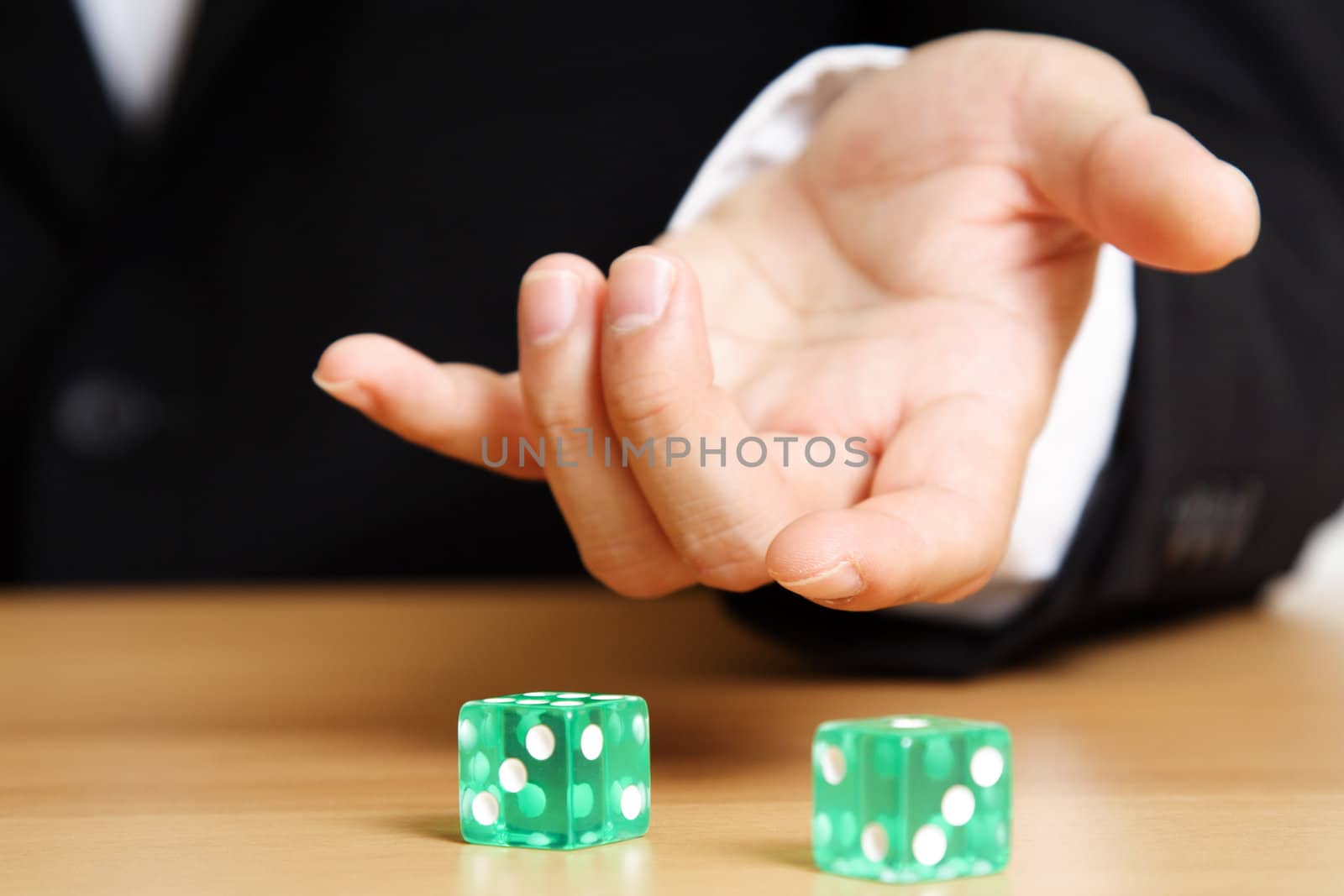 A businessman rolling a dice