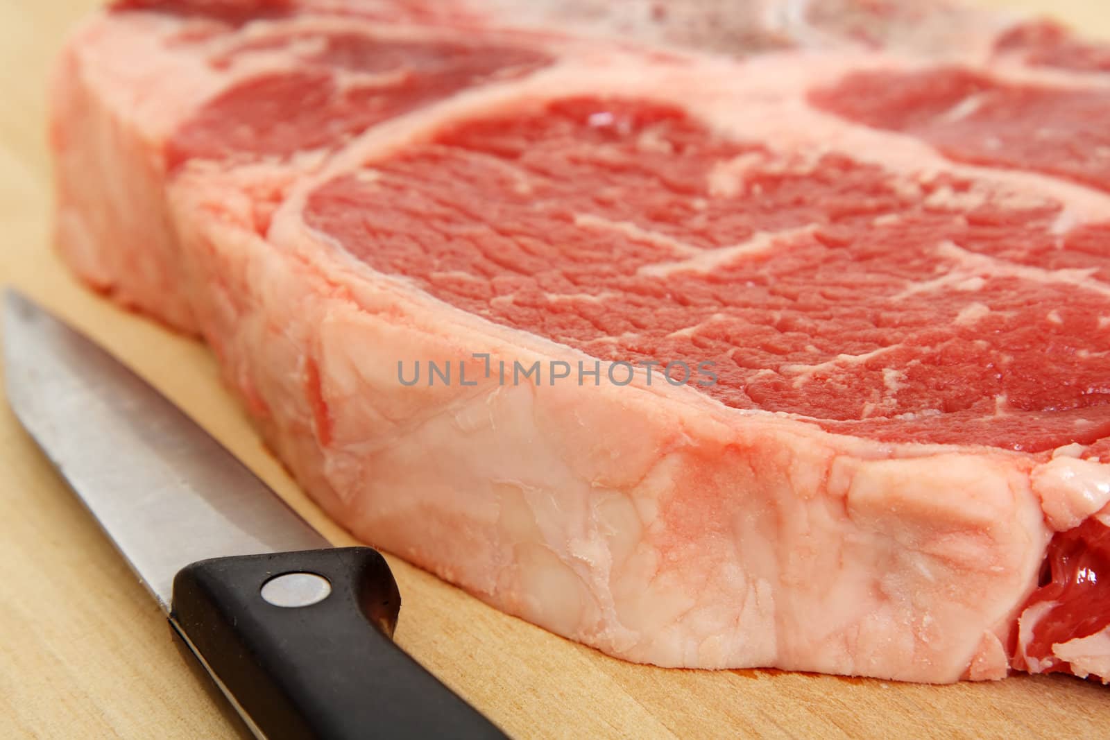 Close up of a ribeye steak and a knife