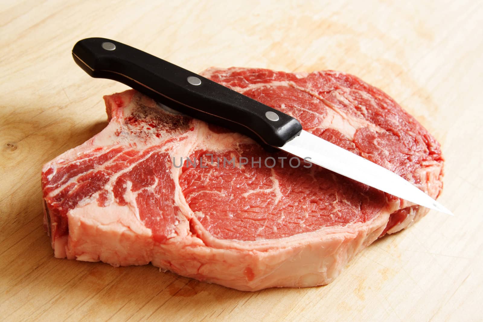 A piece of raw ribeye steak