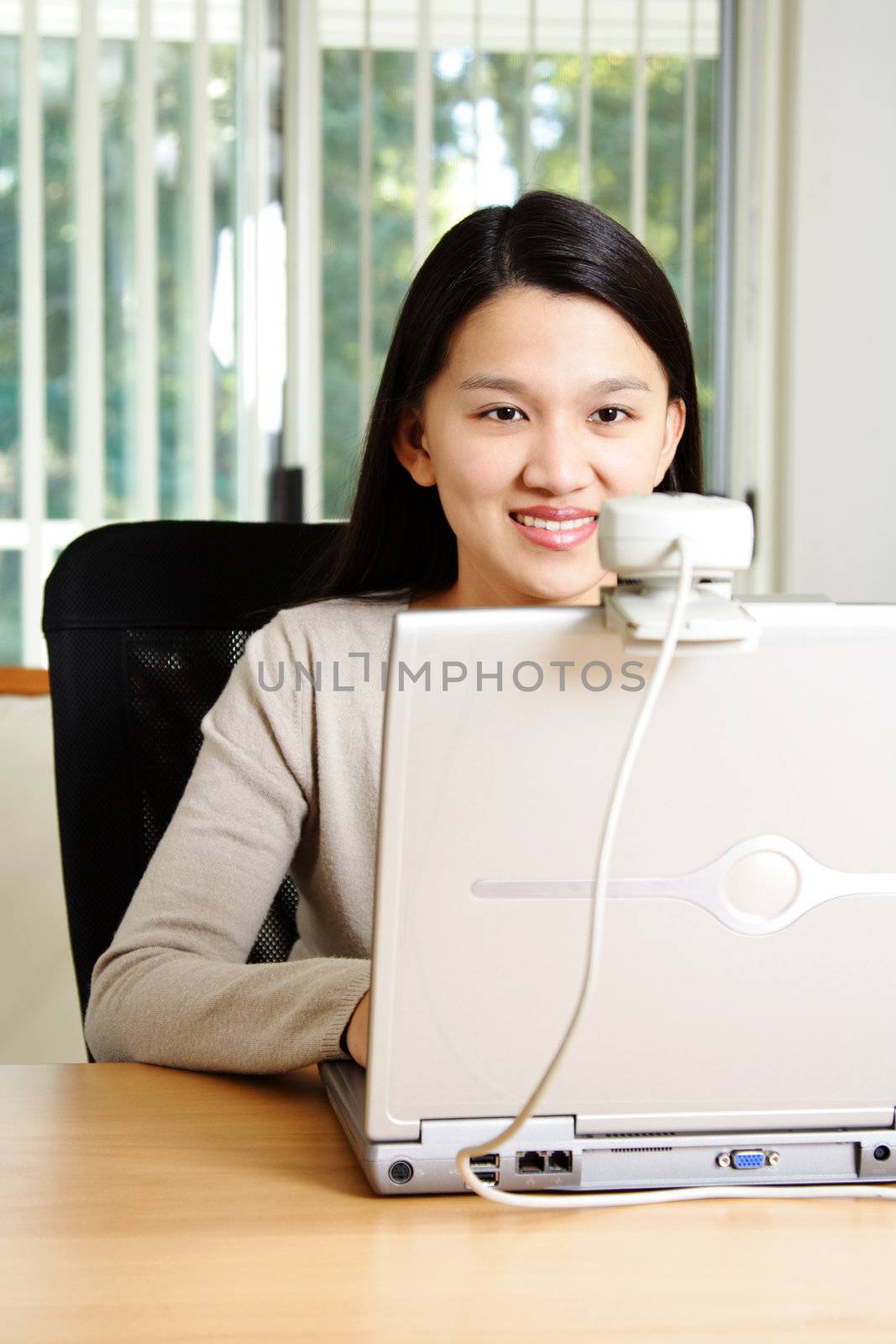 A businesswoman using webcam to communicate