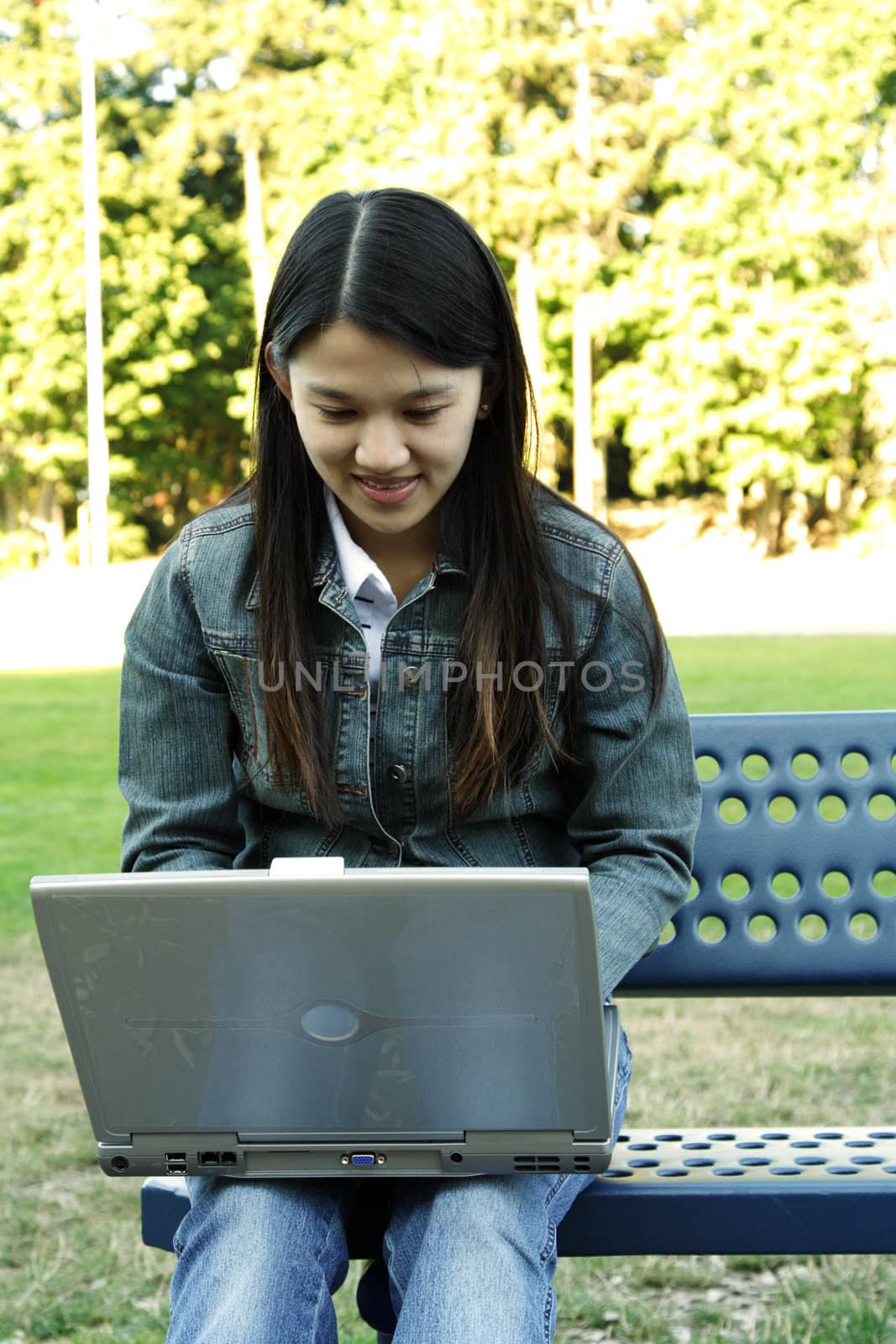 A girl working with her laptop in a park