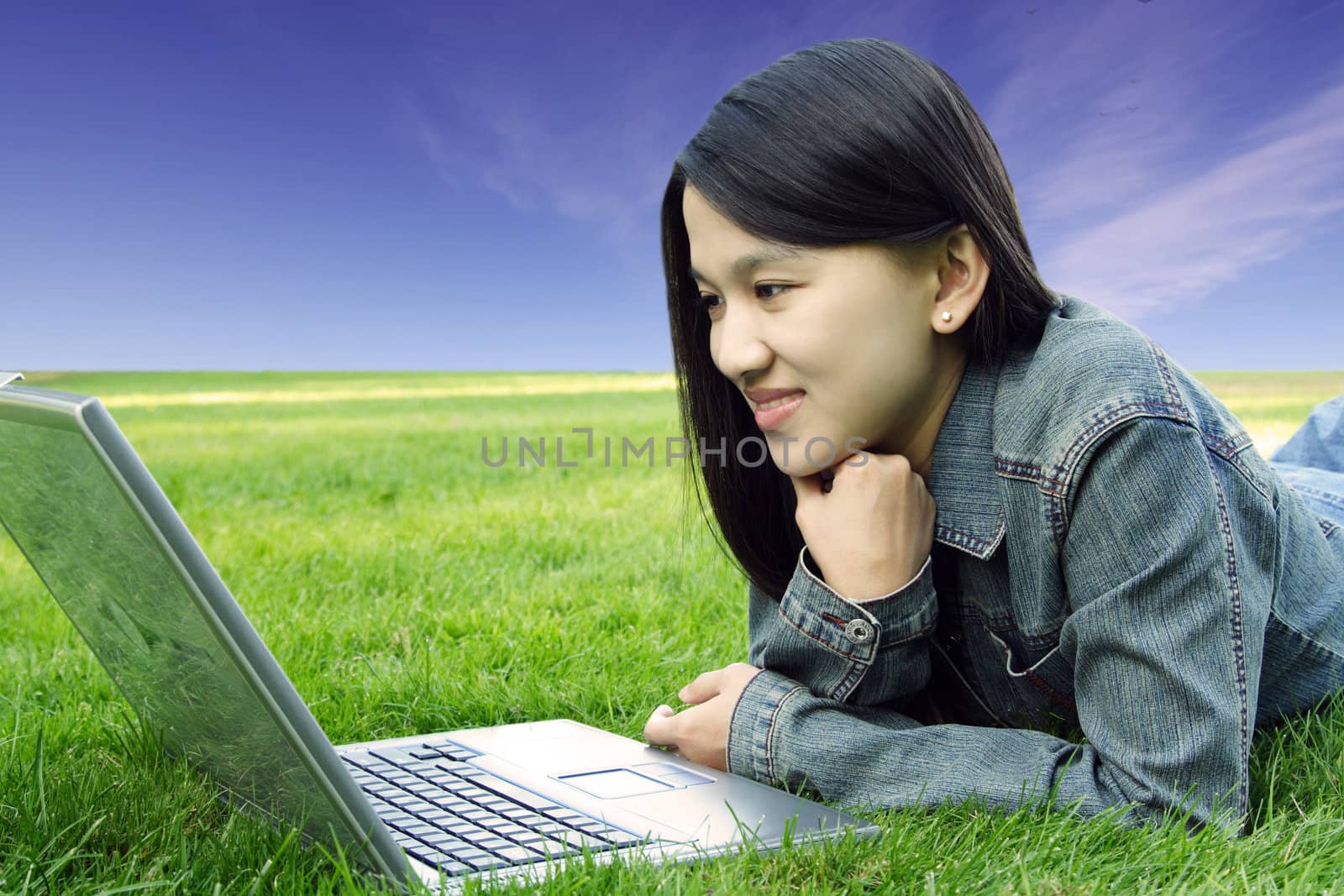 A college student with laptop in a park