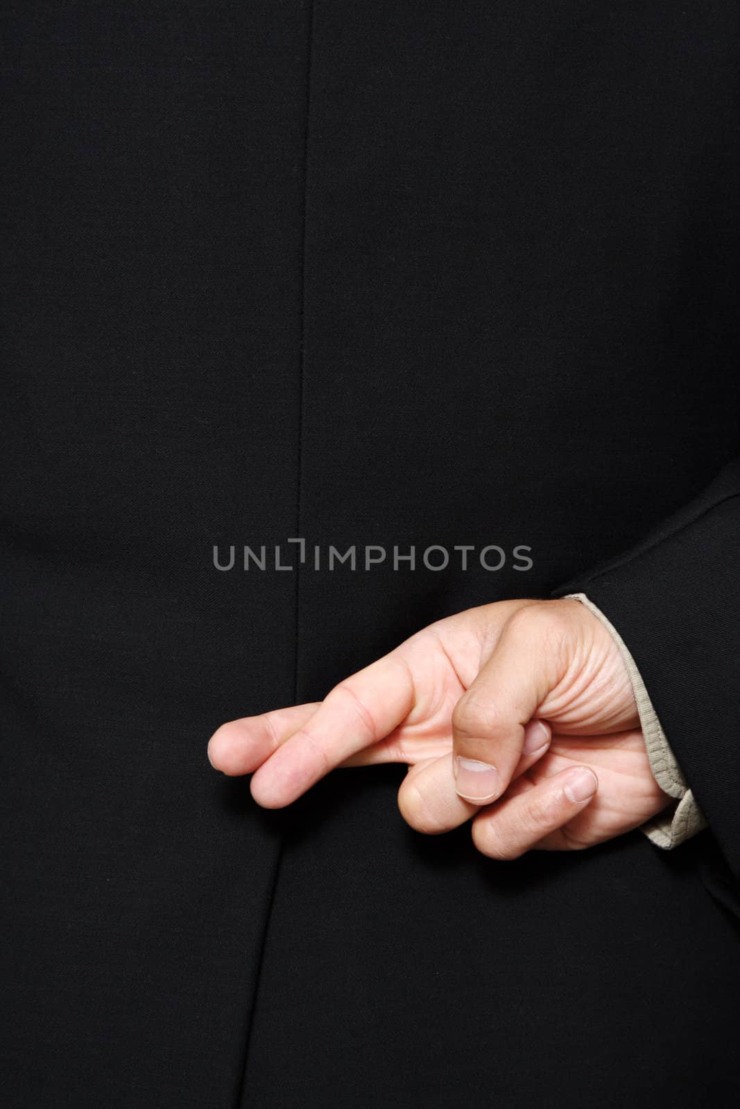 Businessman with his fingers crossed behind his back