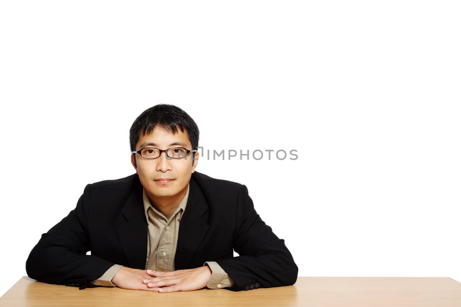 Businessman posing in an office, with copy space