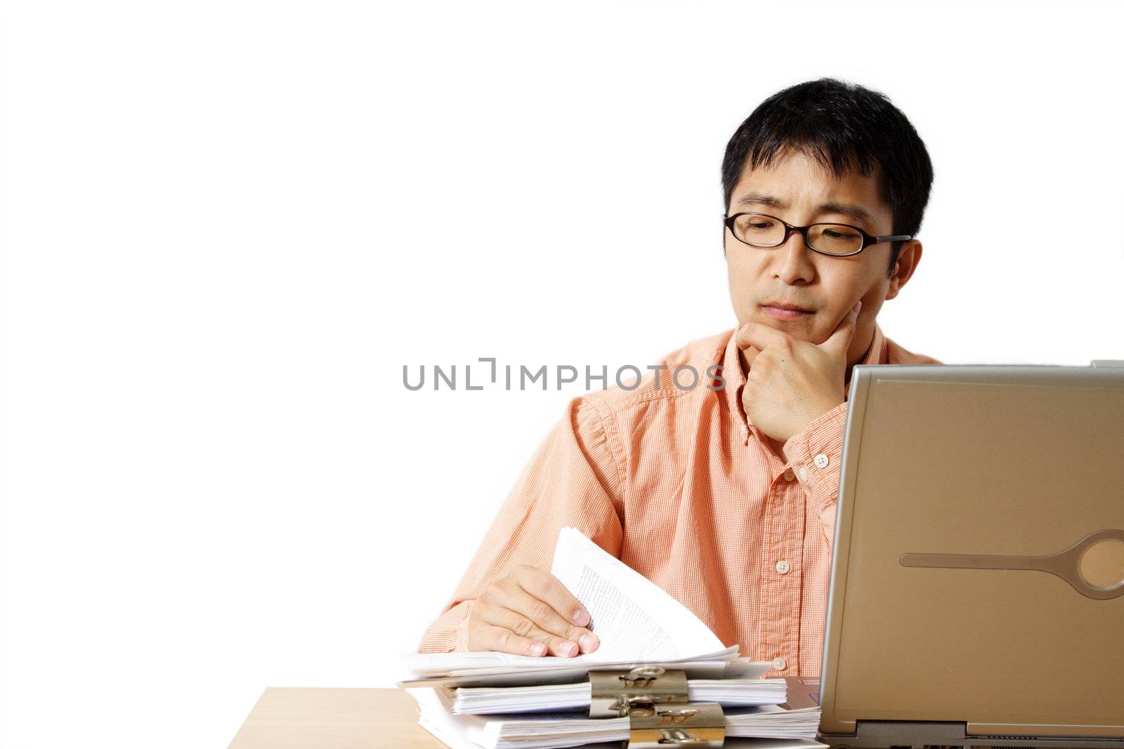 Busy businessman with laptop and a stack of paper