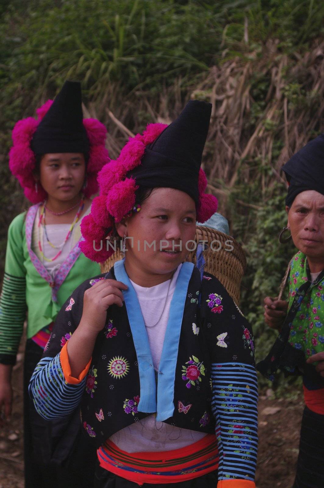 Headdress typical of young Hmong girls red pompoms unmarried. Woman Pha Din Pass