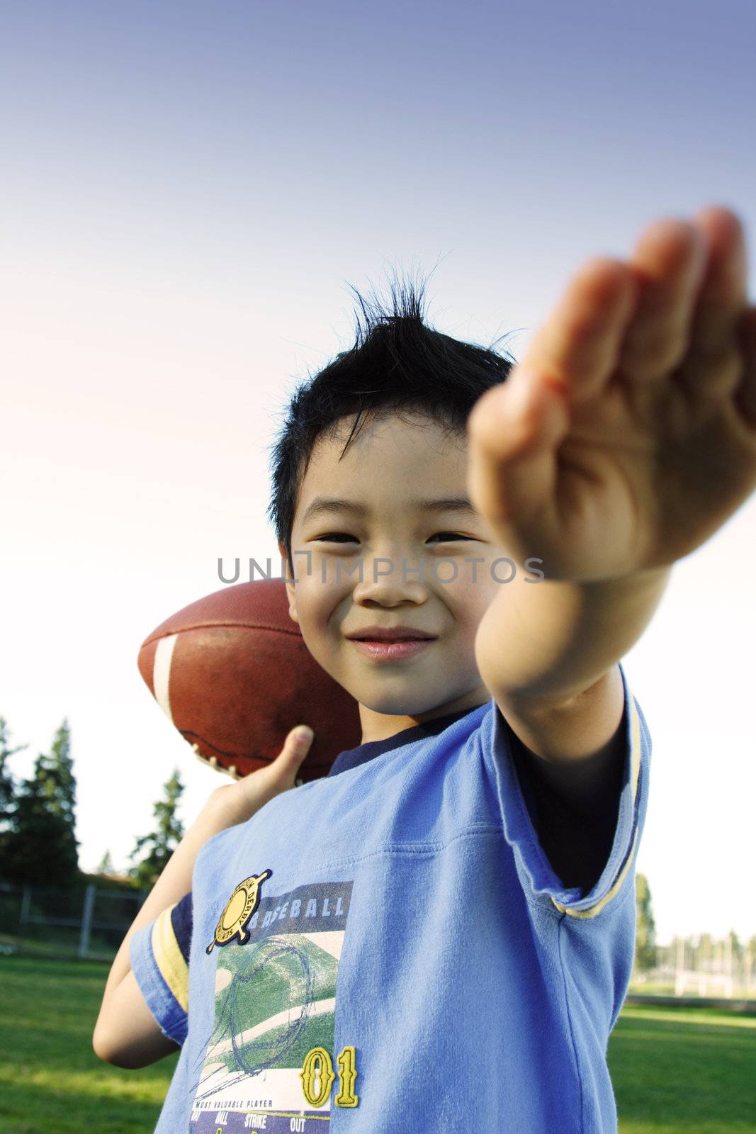 A boy playing football outdoor