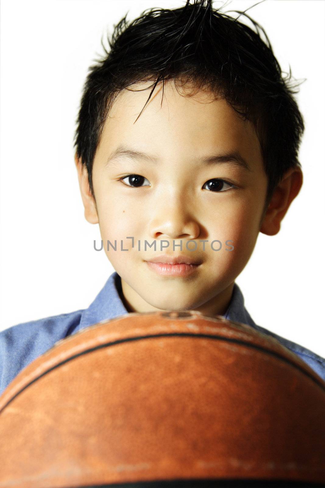 A portrait of a young boy with a basketball
