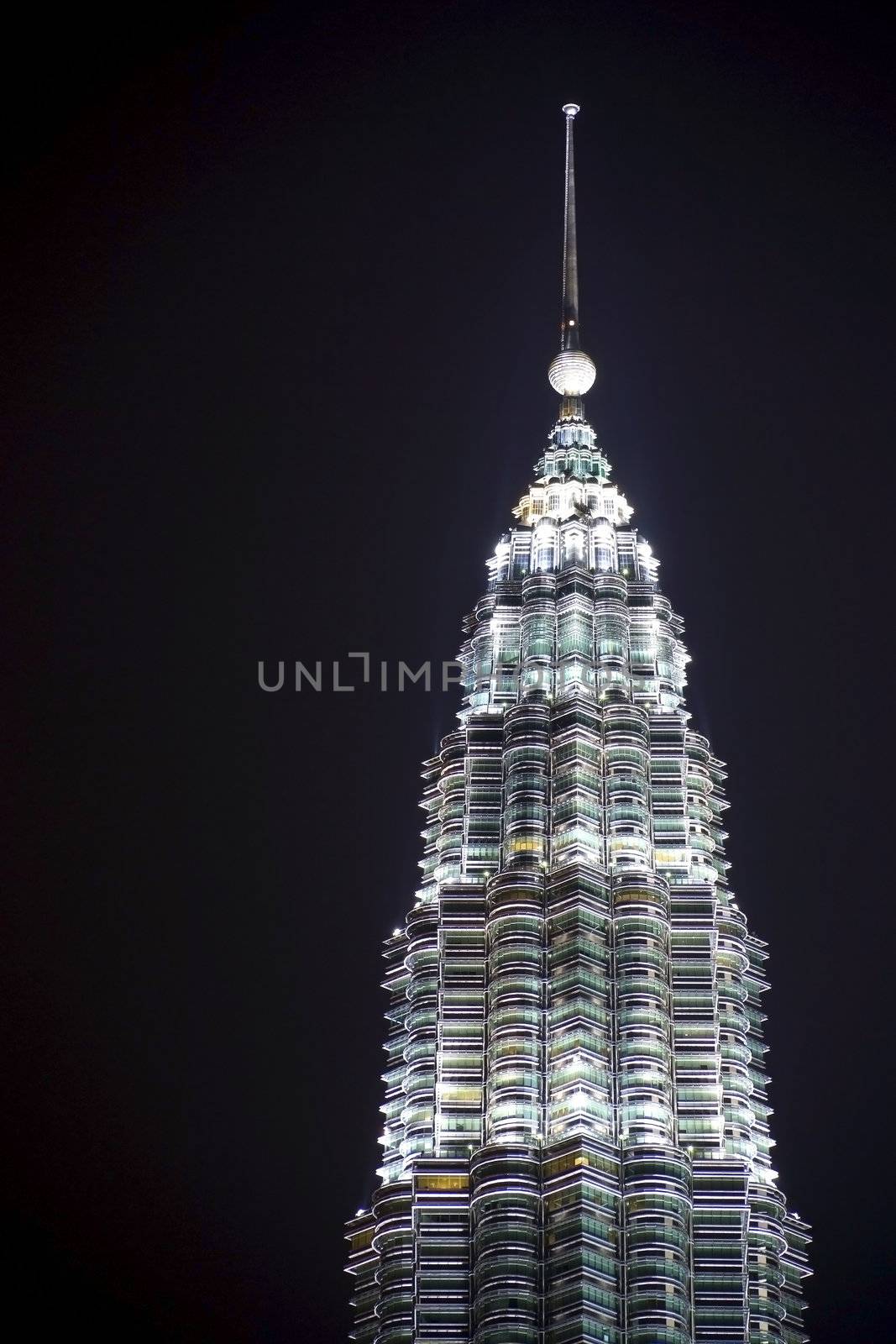 Night image of one of the Petronas Twin Towers in Malaysia.