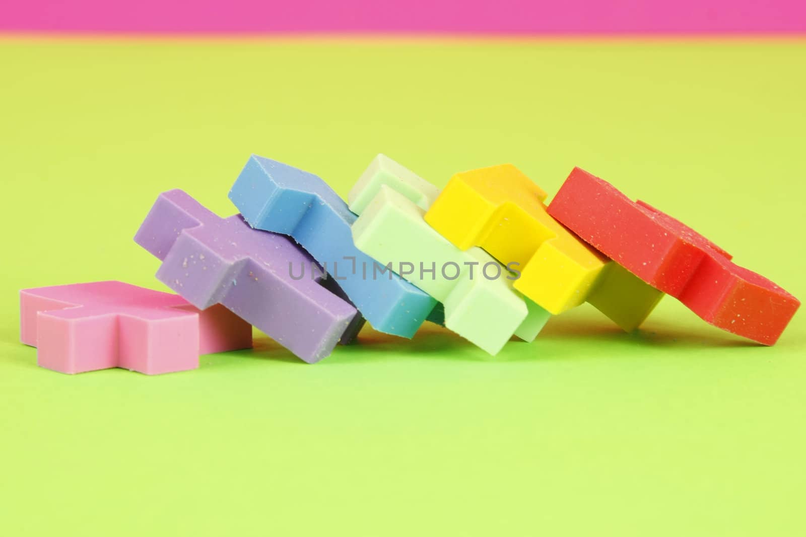 Colorful eraser puzzle pieces in a row laying down.