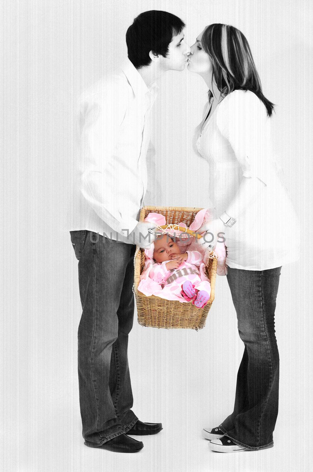 couple holding new baby in basket while kissing by Ansunette