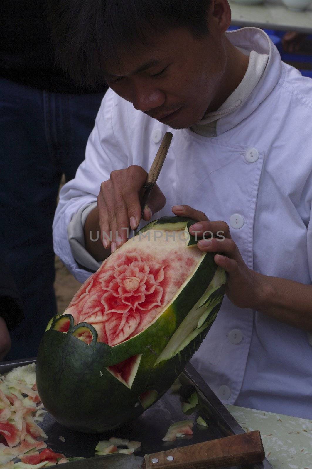 Asians are good makers of miniatures and decorations. With this single knife carve the watermelon man. It's beautiful!