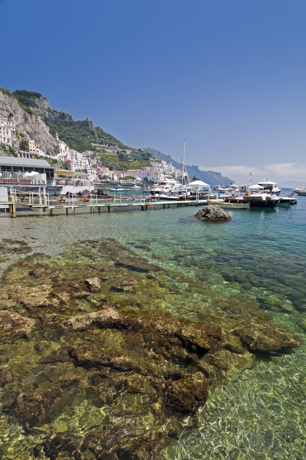 Amalfi Coast, transparent water in the harbor with boat. Naples - Best of Italy