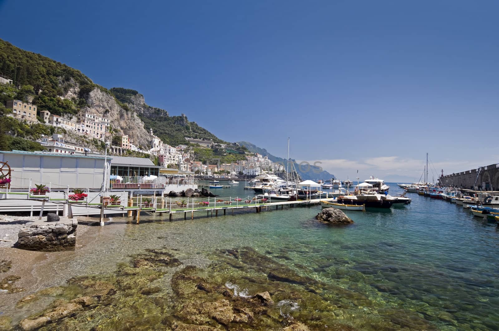 Amalfi Coast, transparent water in the harbor with boat. Naples - Best of Italy