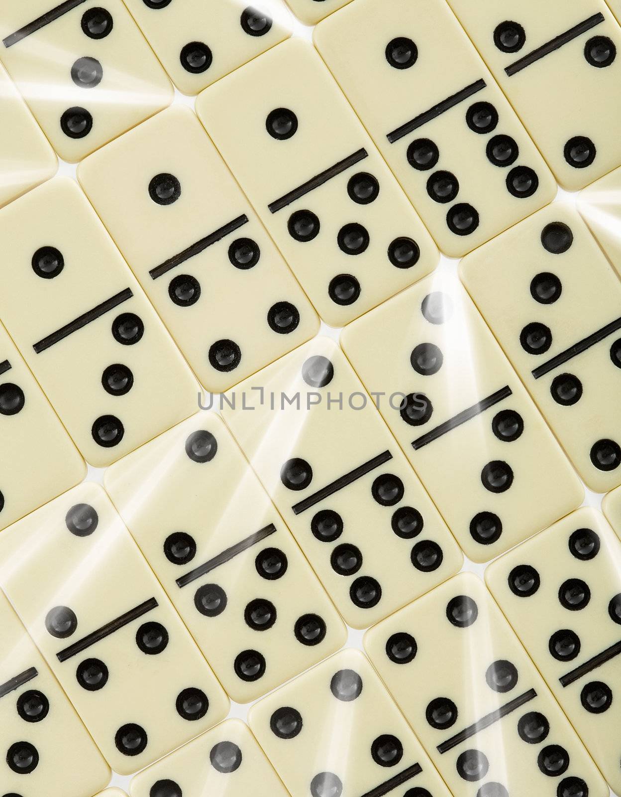 Background from dominoes pieces with white rays