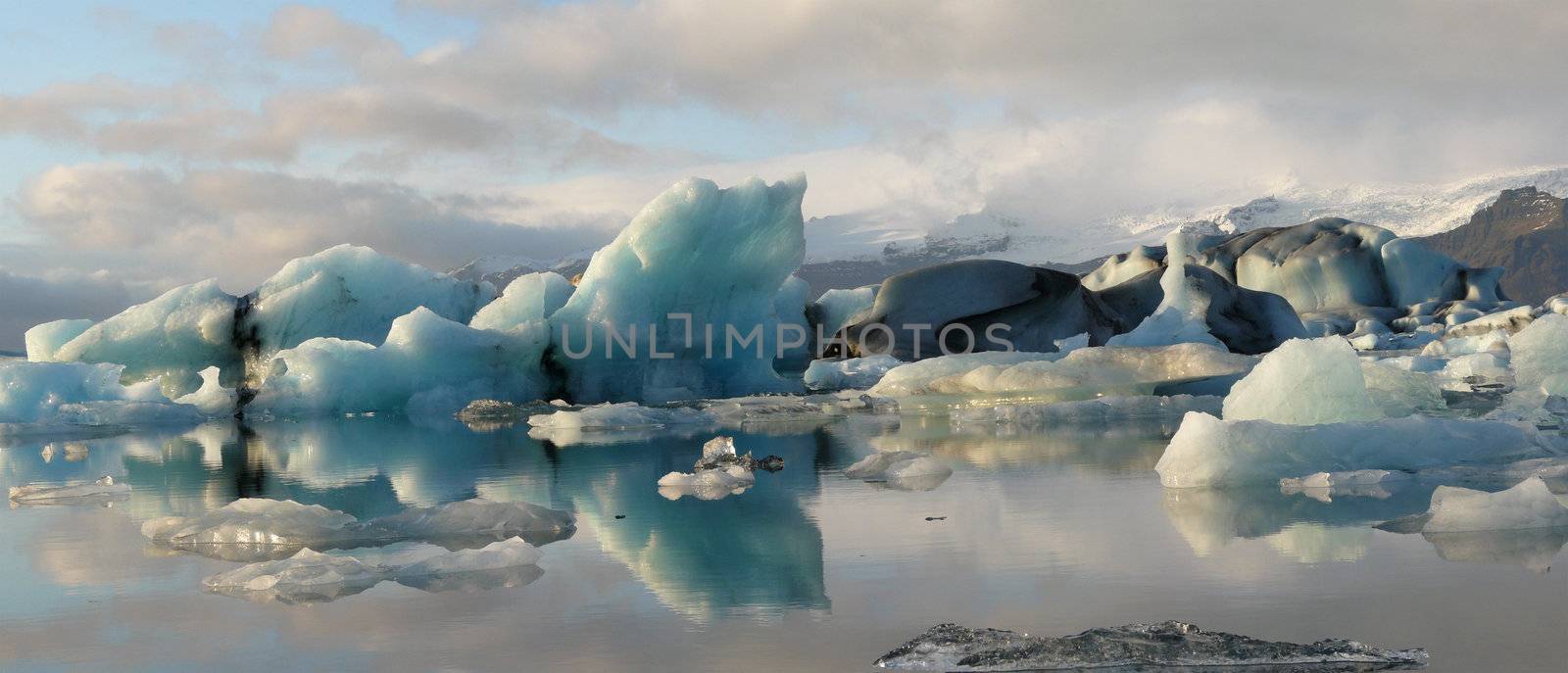 Reflection of floating icebergs in Jokulsarlon glacier lake in Iceland.