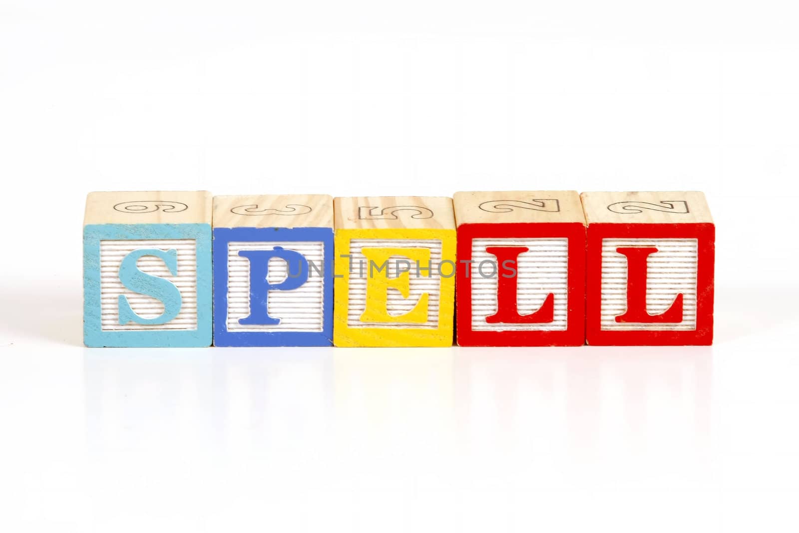 Childrens colorful blocks spell the word spell.
