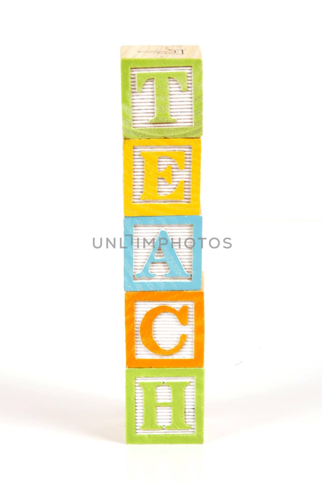 Childrens colorful blocks spell the word teach.