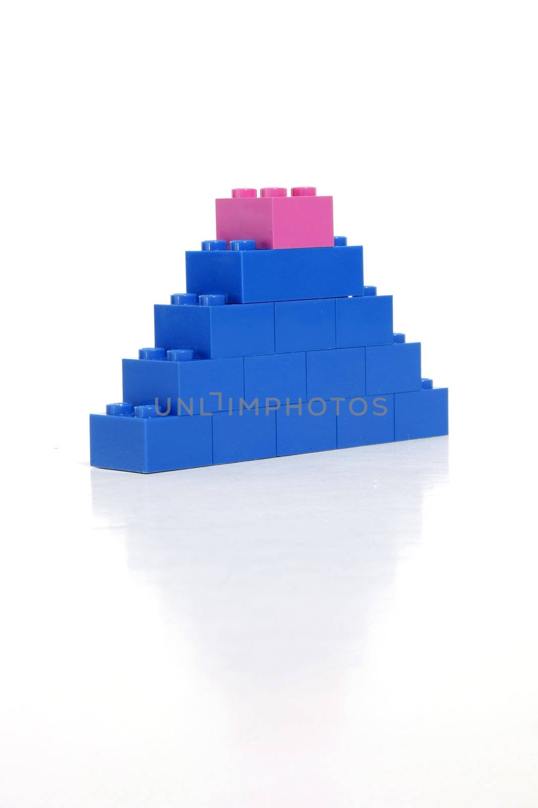 Pink block on top of a blue tower indicates womans strength.
