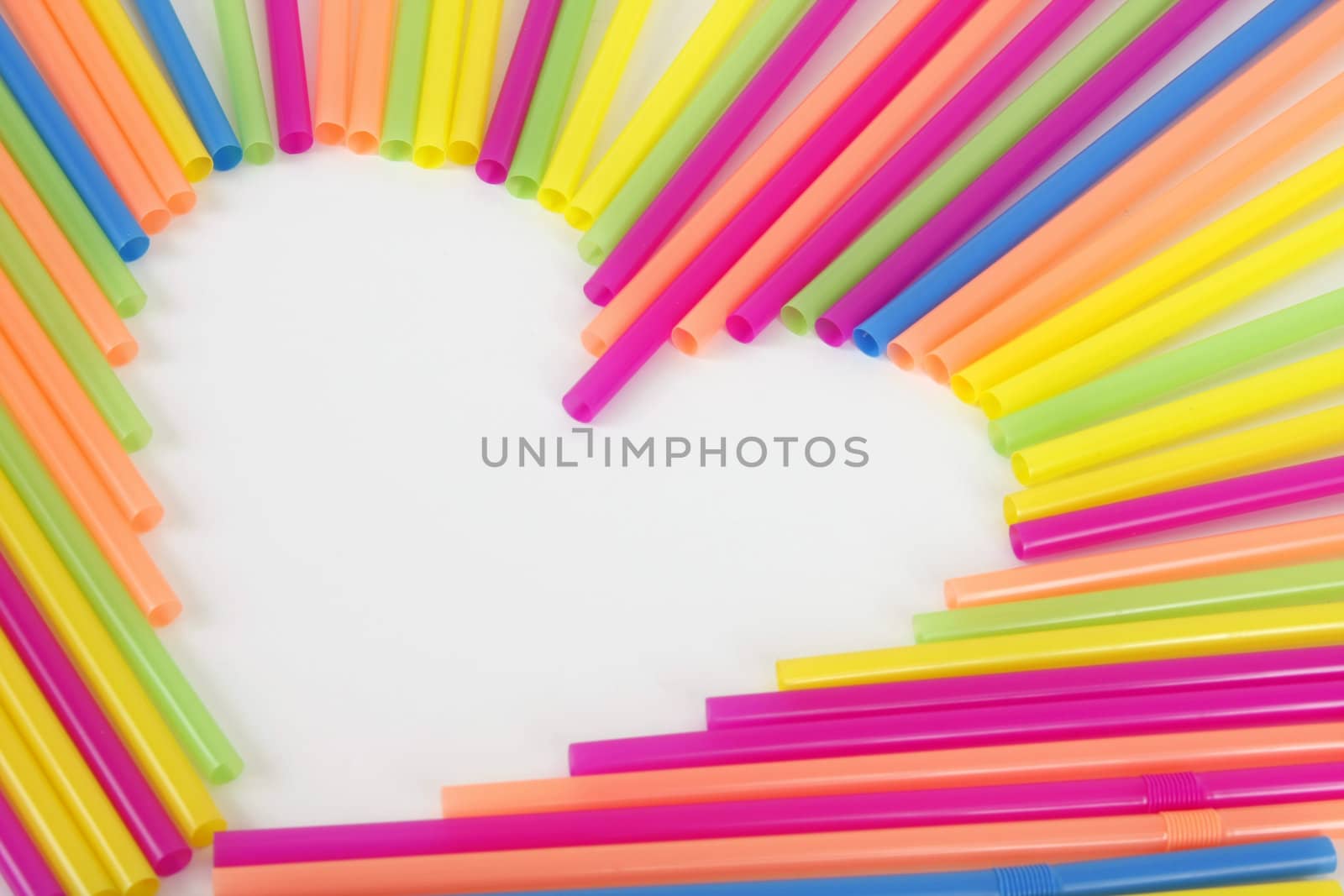 A heart made from colorful straws on a white background.